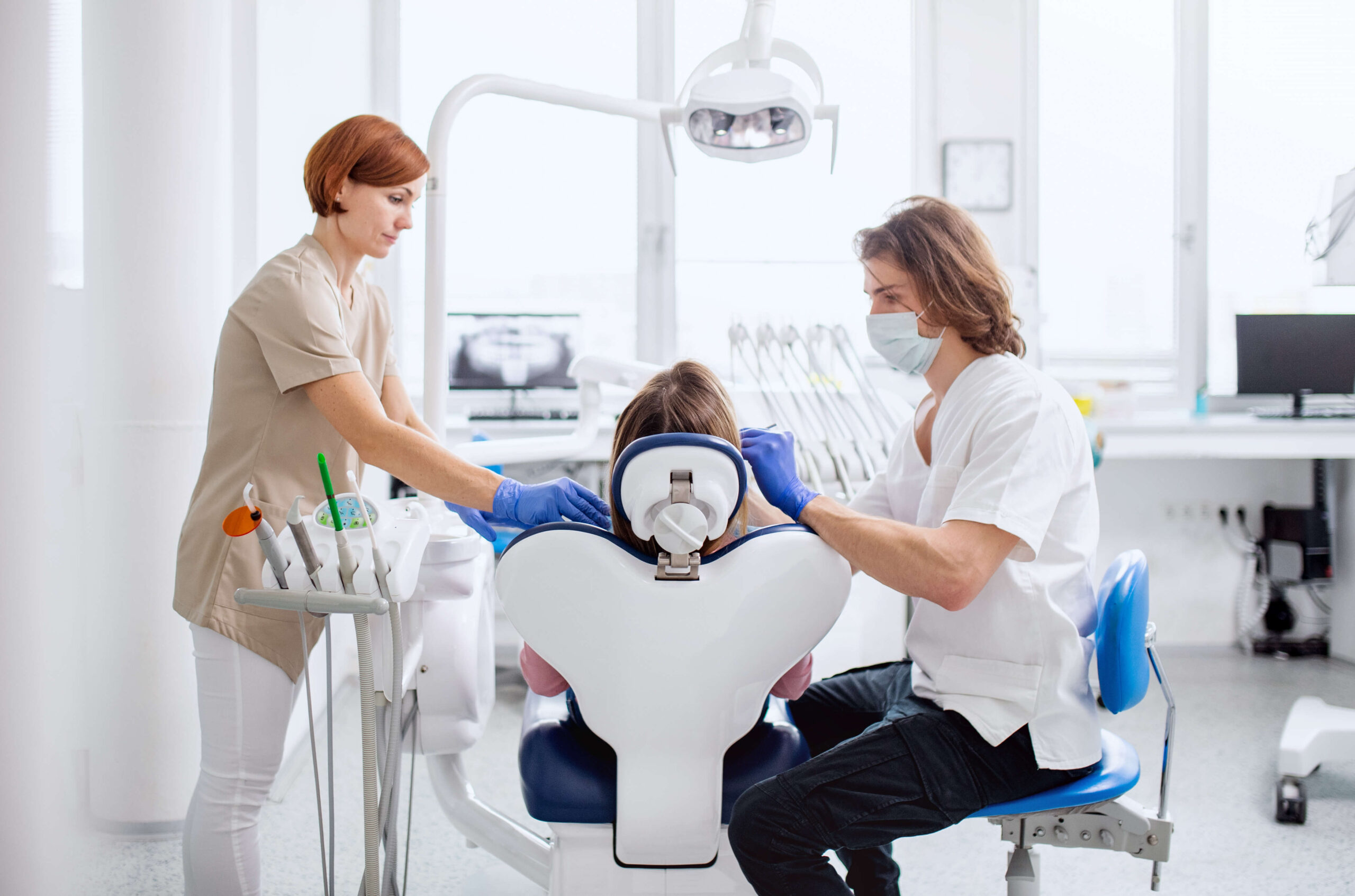 Dentist and car team performing a dental procedure