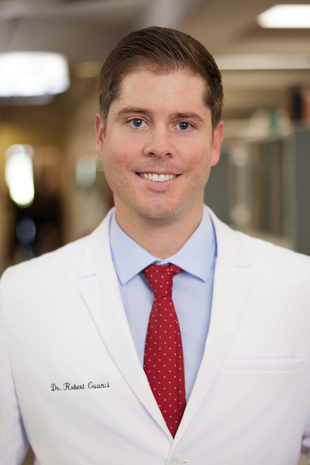 Dr. Robert Guanci smiling at the camera in a doctor coat
