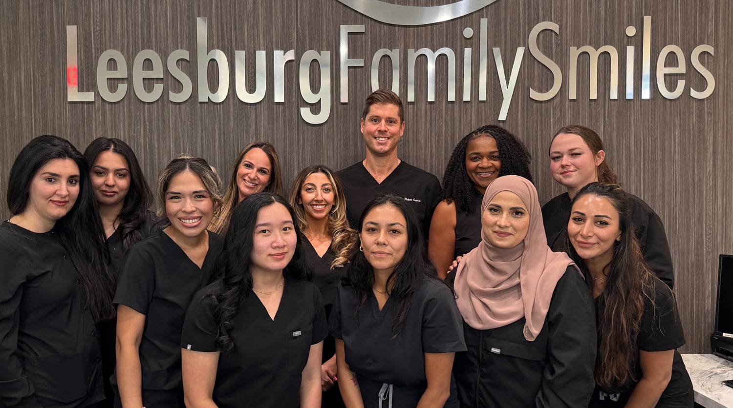 The dentists and team at Leesburg Family Smiles smiling at the camera together